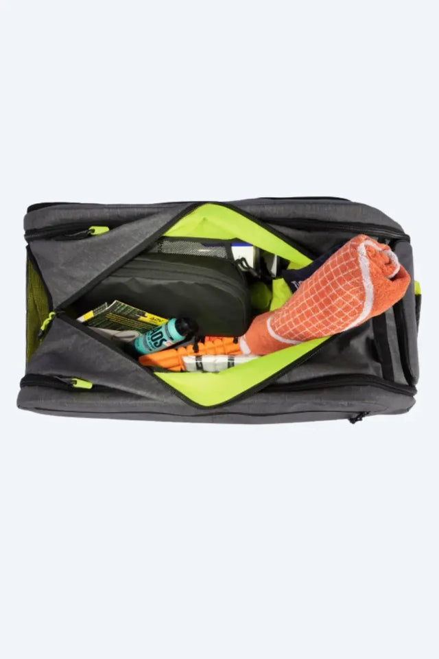 tennis practice equipment neatly organized inside a spacious tennis bag with towel, resistance bands, and gear